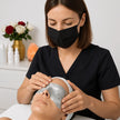 Profesional aplicando tratamiento Eye Perfection en el contorno de ojos de una mujer